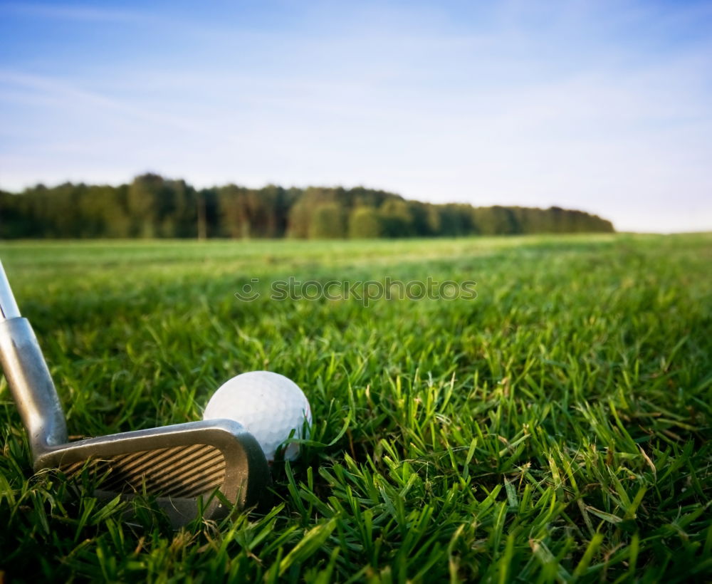 Similar – Golfer performs a golf shot from the fairway