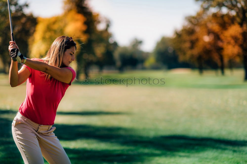 Similar – Female golfer practicing on a driving range