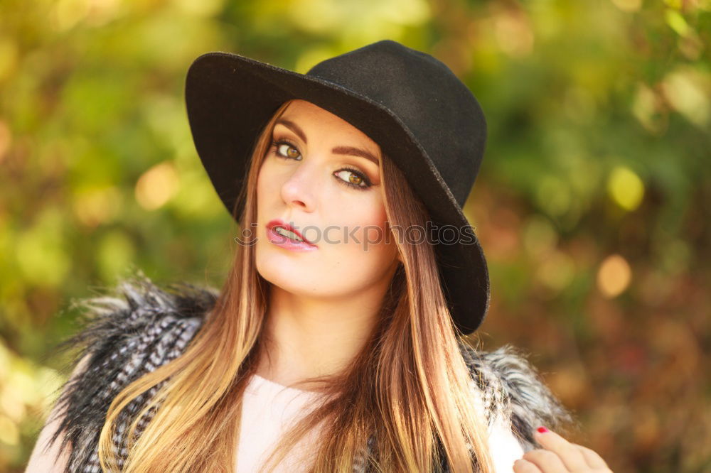 Similar – smiling young woman wearing winter coat with fake fur hood