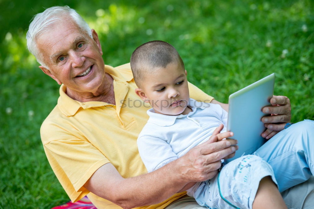 Similar – Image, Stock Photo Senior man and child reading a newspaper outdoors