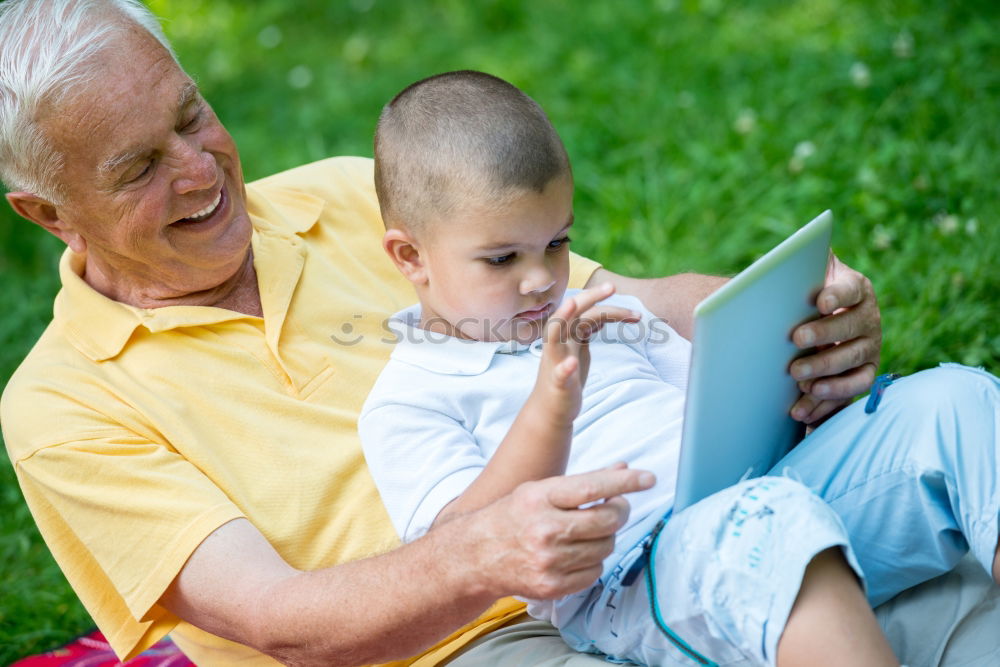 Similar – Image, Stock Photo Senior man and child reading a newspaper outdoors