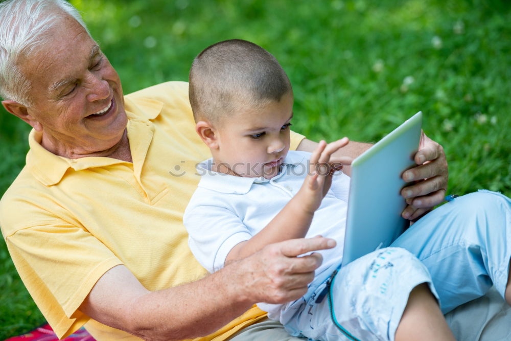 Similar – Image, Stock Photo Senior man and child reading a newspaper outdoors