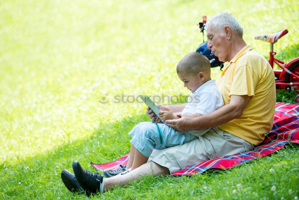 Similar – Image, Stock Photo Senior man and bored child reading newspaper outdoors