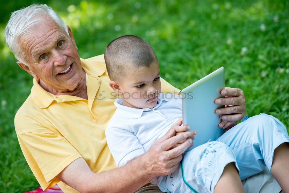 Similar – Image, Stock Photo Senior man and child reading a newspaper outdoors