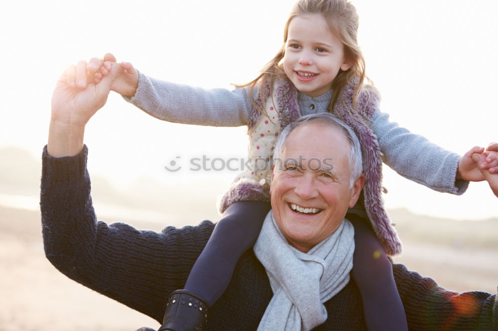 Similar – Image, Stock Photo Baby girl playing with hat of senior man over a nature background