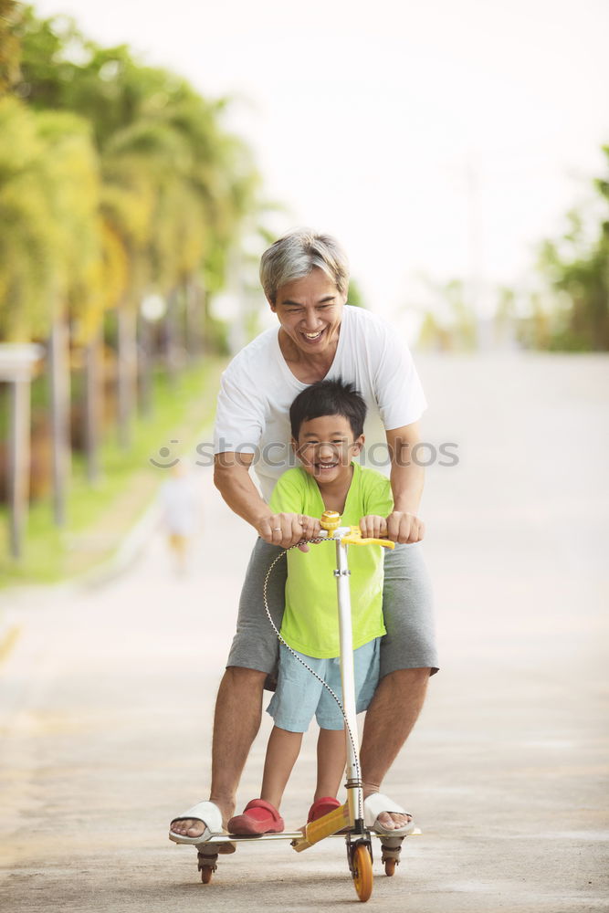 Similar – Father and daughter playing on the road at the day time.