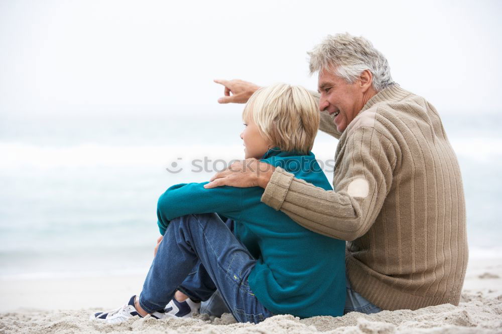 Similar – Grandfather With His grandson on the lake. Back view