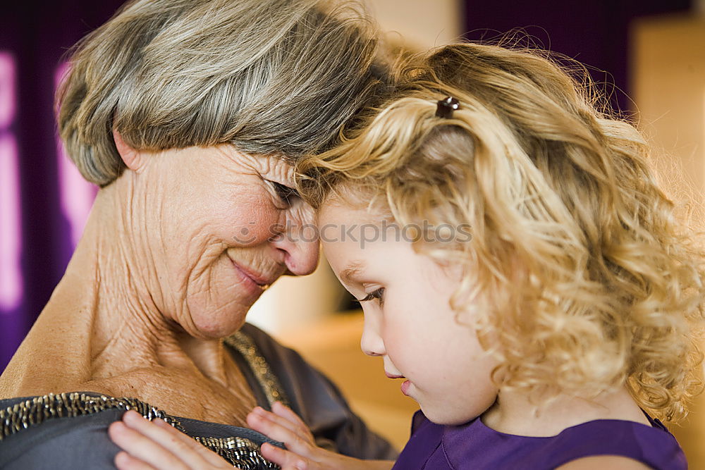 Similar – Adult woman holding a child eating a strawberry