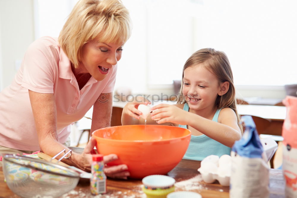 Similar – Image, Stock Photo Little sisters cooking with her mother in the kitchen.