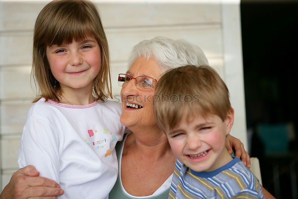 Similar – Adult woman holding a child eating a strawberry