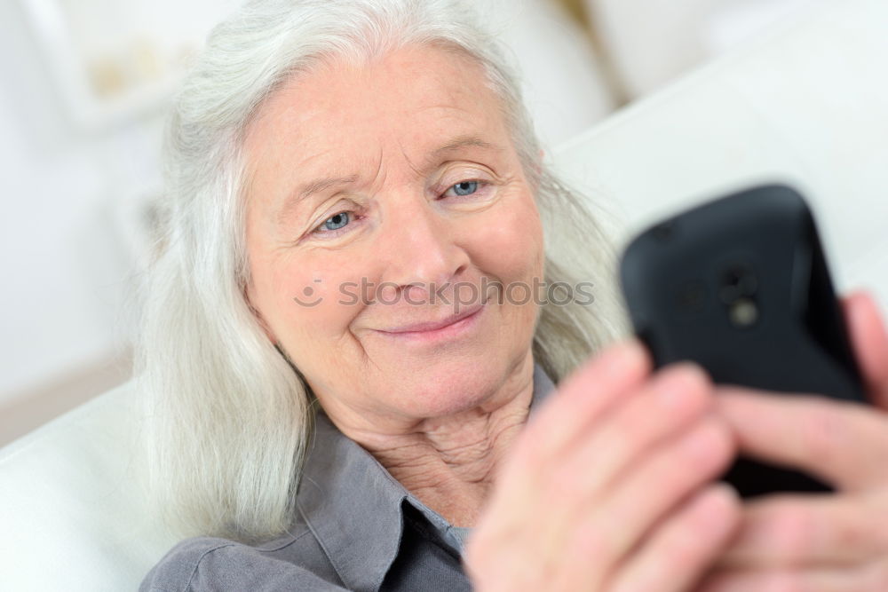 mature woman taking a selfie with smartphone