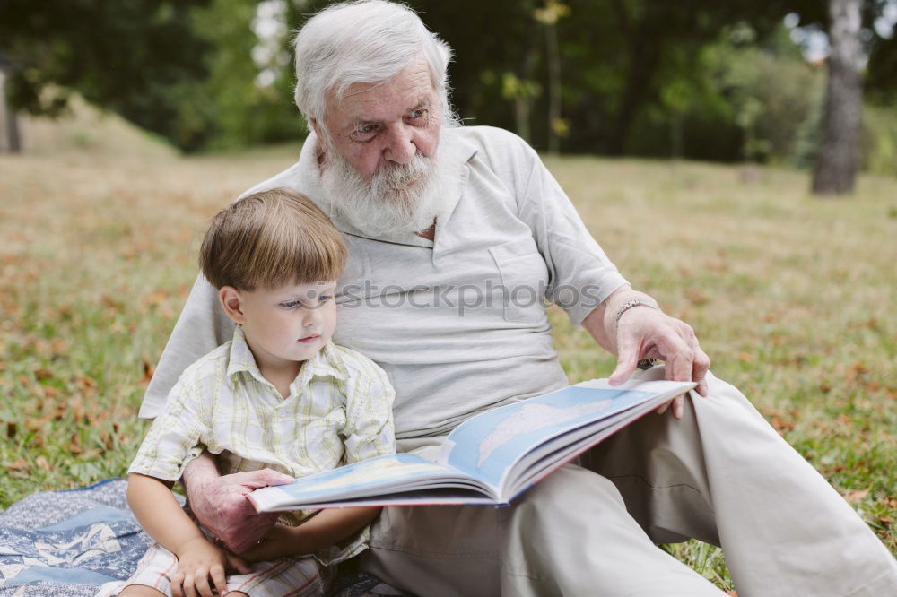 Image, Stock Photo Senior man and child reading a newspaper outdoors