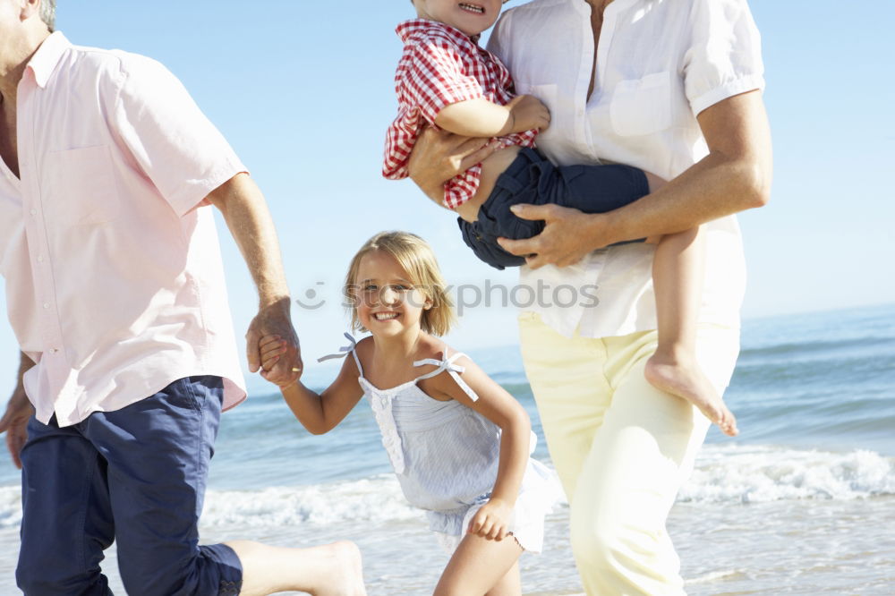 Similar – Father and children playing on the beach at the day time. Concept of friendly family.