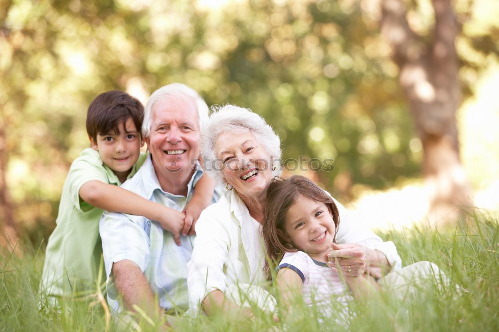 Similar – Image, Stock Photo Baby girl playing with hat of senior man over a nature background