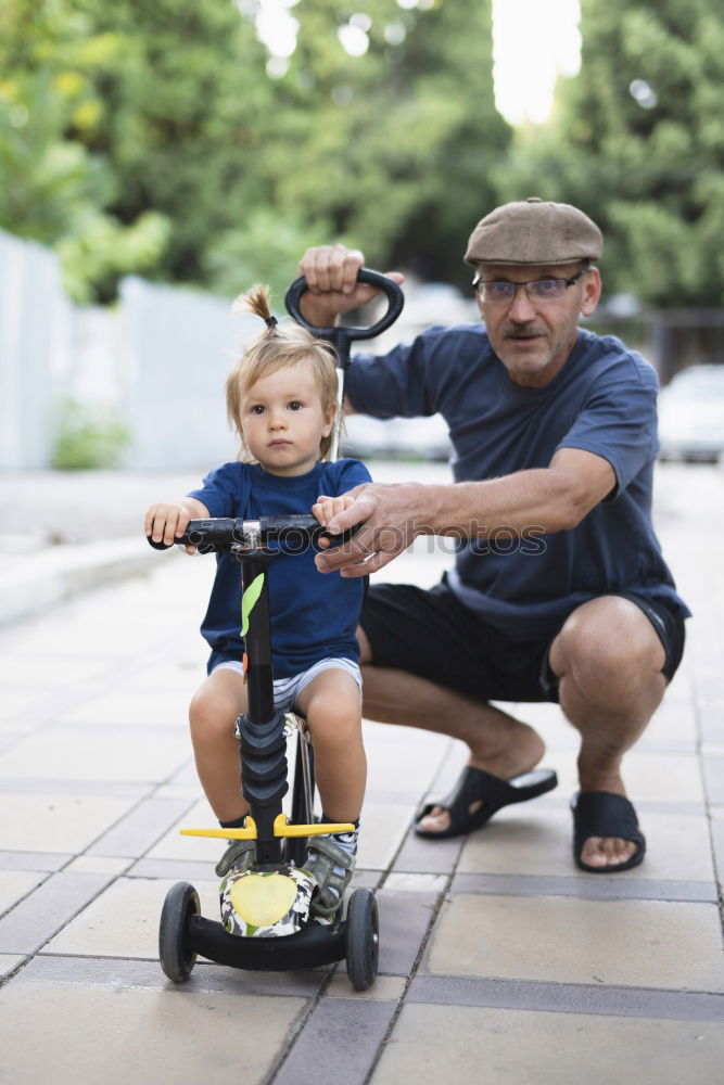 Similar – Father and daughter playing on the road at the day time.