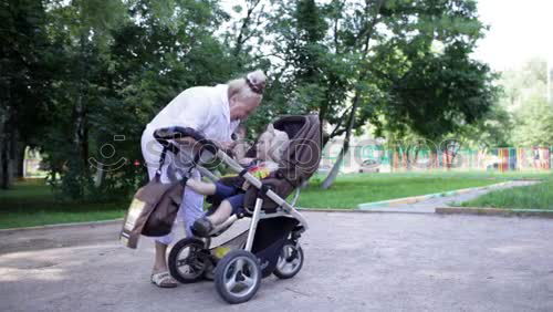 Similar – Foto Bild Oma spielt mit ihrem Enkel im Kinderwagen im Garten.