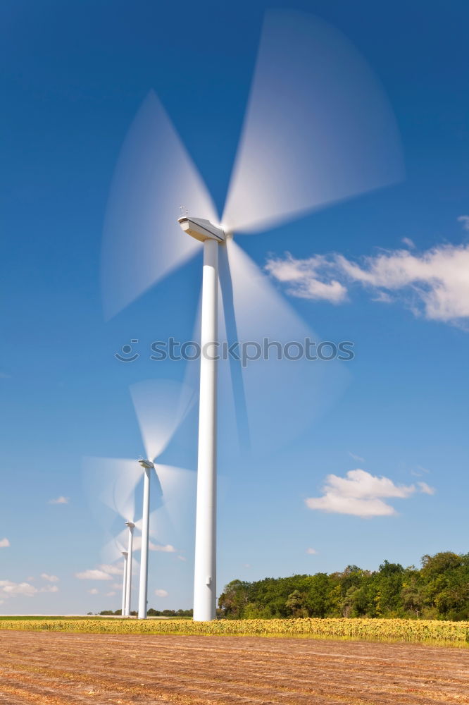 Similar – Image, Stock Photo Wind turbine for renewable power generation in front of a dike on the North Sea coast, long straight road. Wind turbine