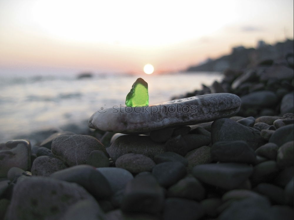 Similar – Glass orb on rocks by the sea covered