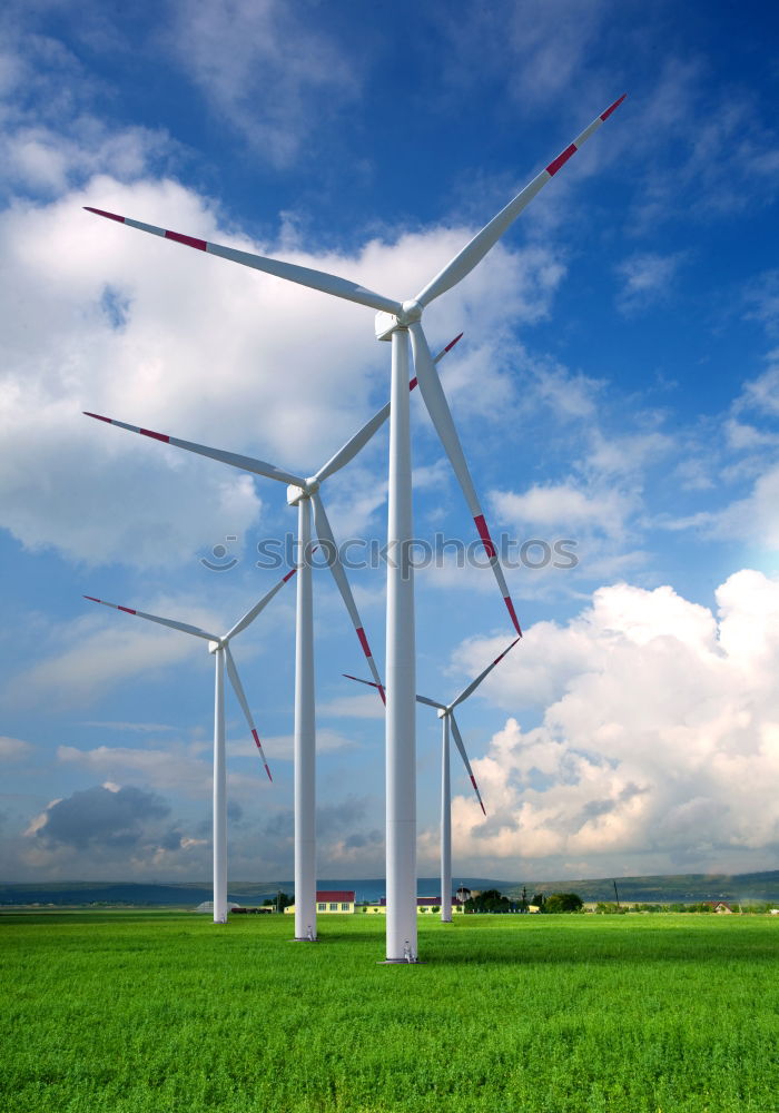 Similar – Image, Stock Photo Wind turbine for renewable power generation in front of a dike on the North Sea coast, long straight road. Wind turbine