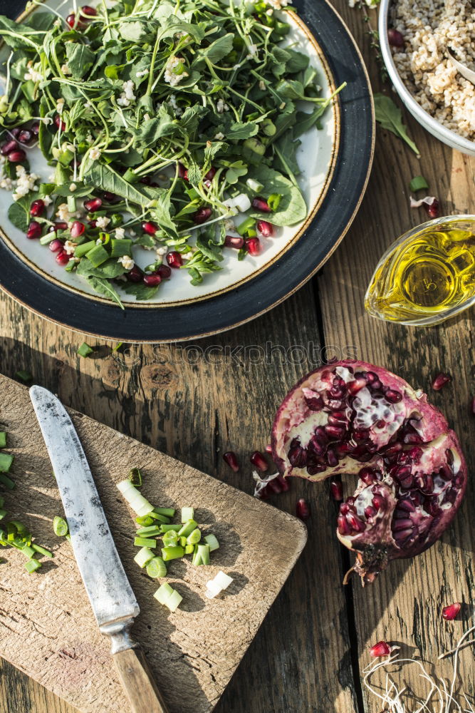 Green salad with pomegranate, manna croup, onion