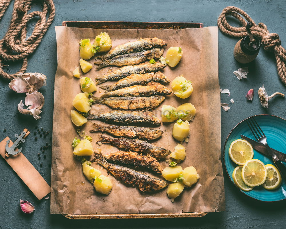 Image, Stock Photo Grilled sardines on baking tray with ingredients: lemon, garlic and herbs for tasty seafood eating. Cooking preparation of fishes