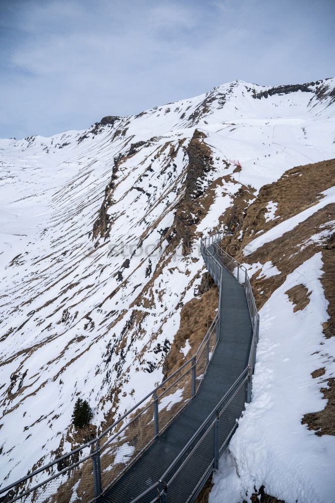 Image, Stock Photo Cyclist goes downhill along a mountain road in a snowy landscape