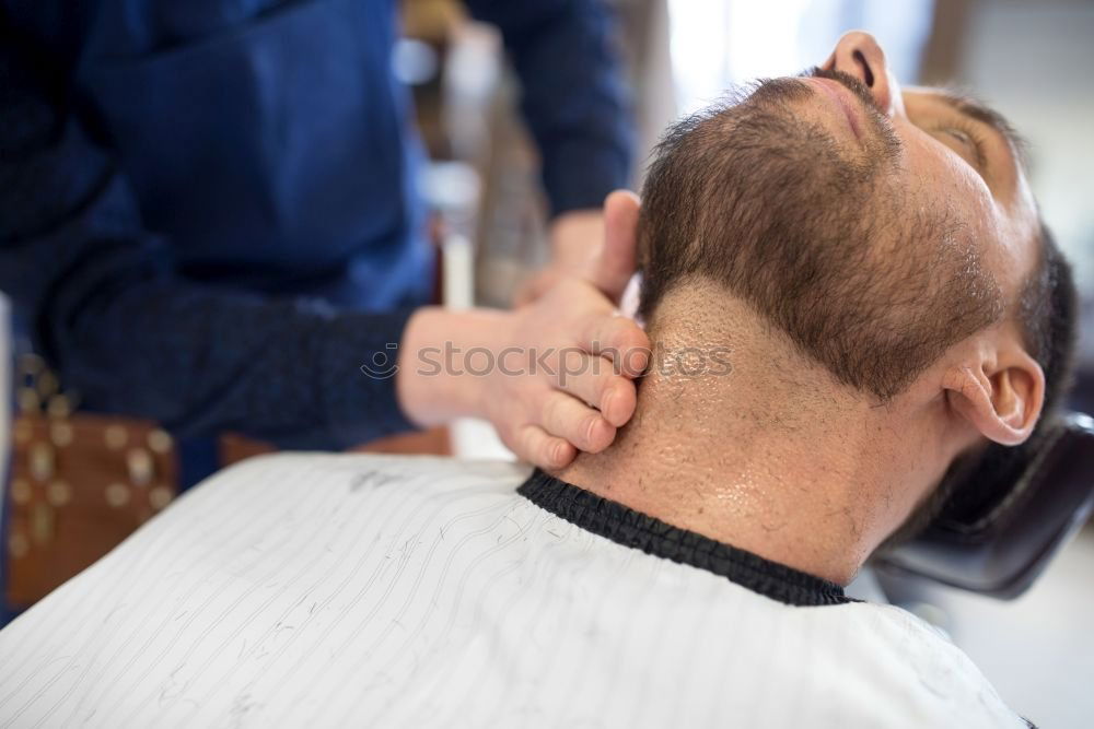 Similar – Barber doing face massage to man