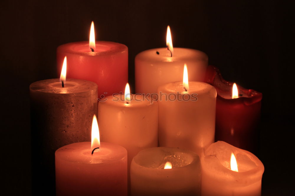 Many colourful burning candles