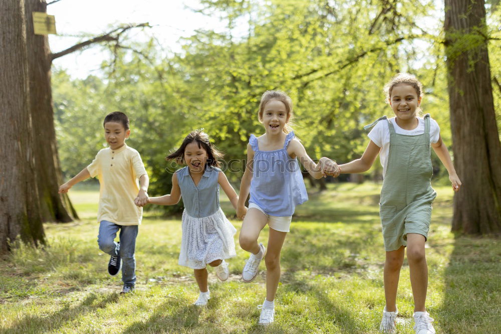 Similar – Children have fun running in nature