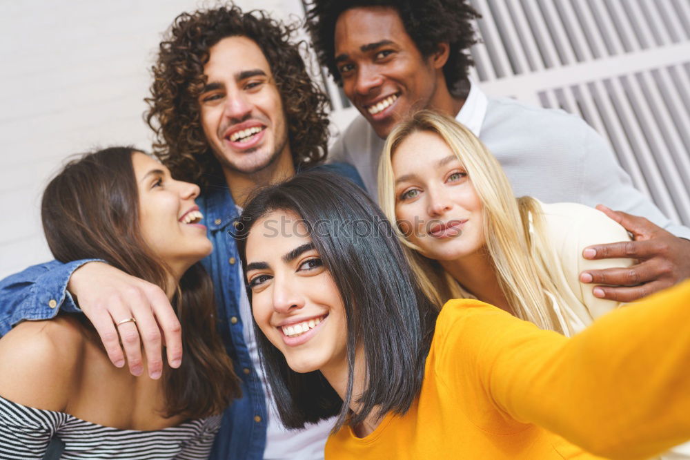 Similar – Multiracial group of friends taking selfie in a urban park