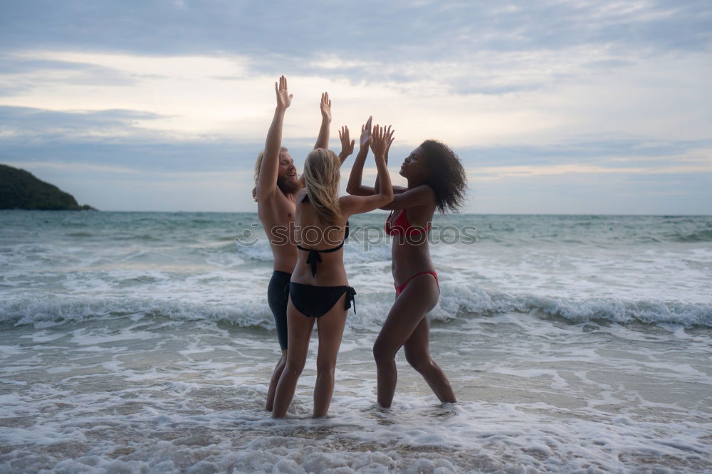 Similar – Image, Stock Photo Group of younf adult friends walking on the beach