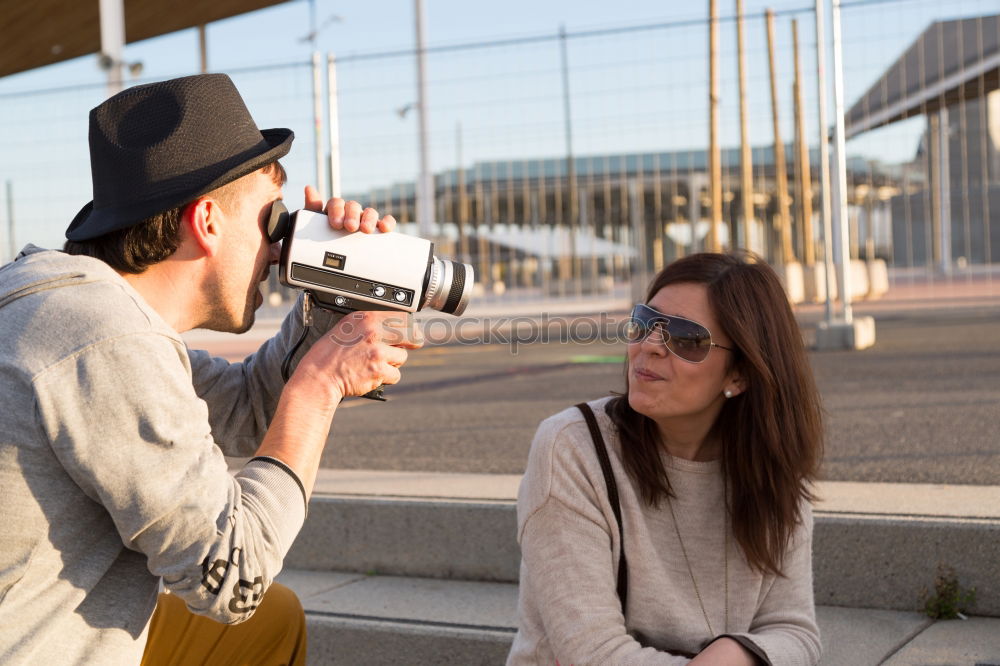 Similar – Image, Stock Photo two friends in the street taking pictures with mobile phone