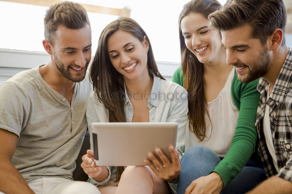 Similar – Multiracial group looking at a tablet computer outdoors