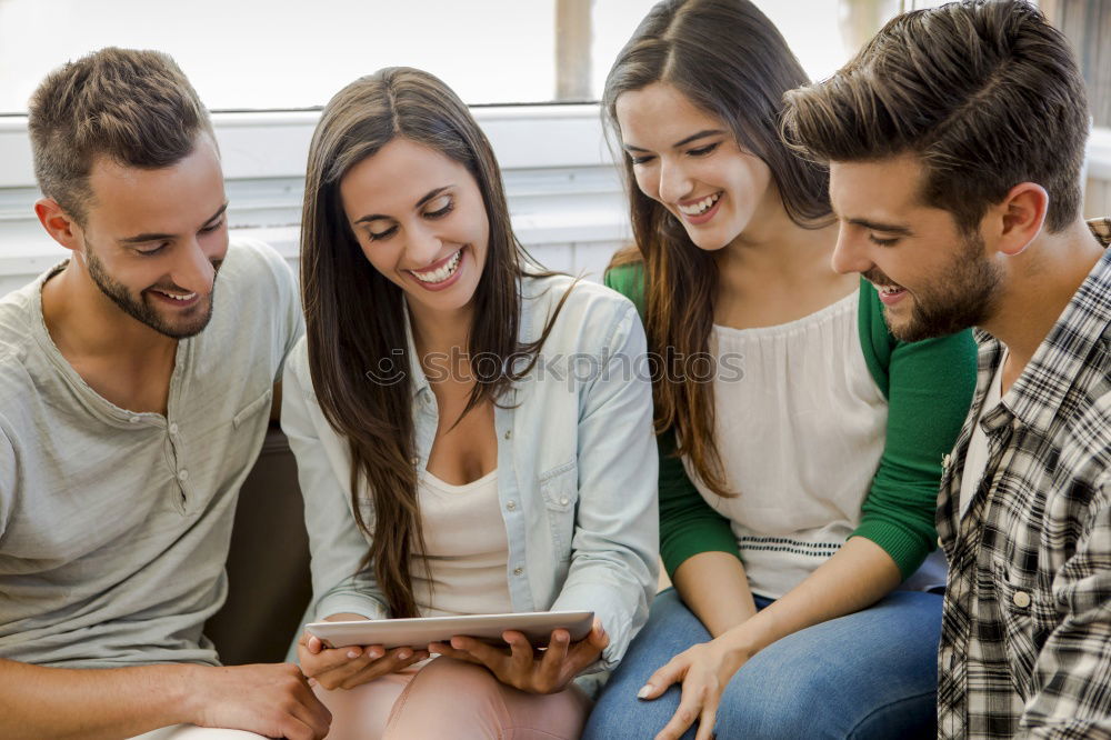 Similar – Multi-ethnic group of people looking at a tablet computer