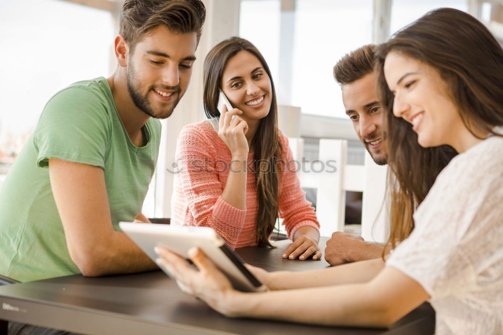 Similar – Multi-ethnic group of people looking at a tablet computer