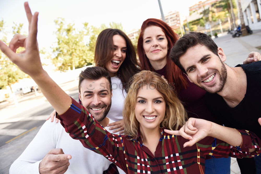 Group of friends taking selfie in urban park