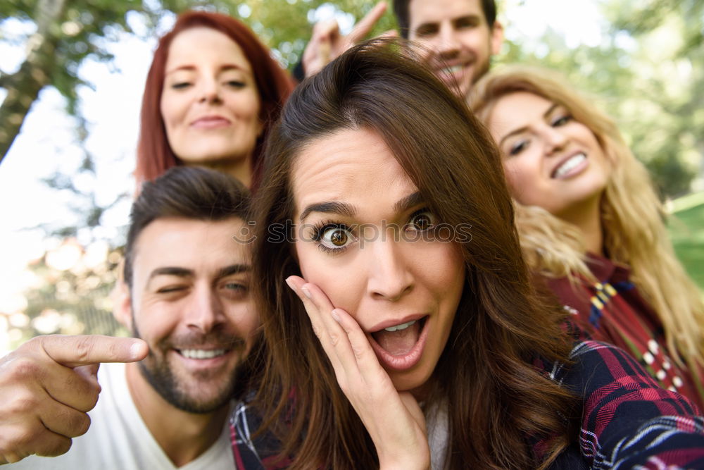 Group of friends taking selfie in urban park