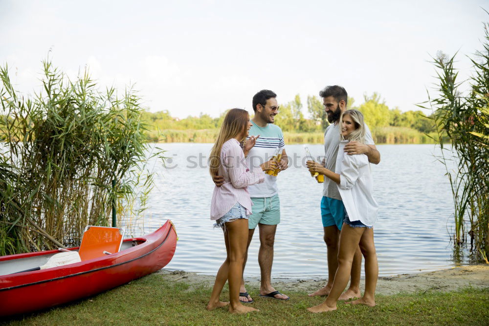 Similar – Family spending vacation time together having a snack sitting on jetty over the lake on sunny day in the summertime