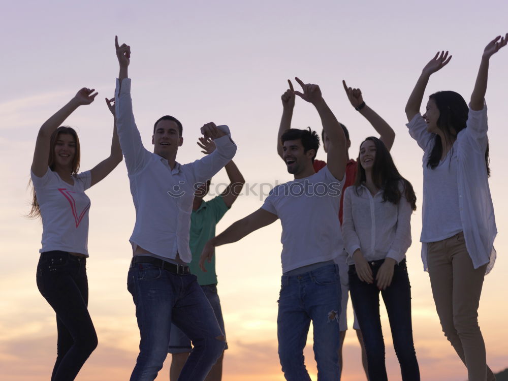 Multi ethnic group of friends dancing on music festival