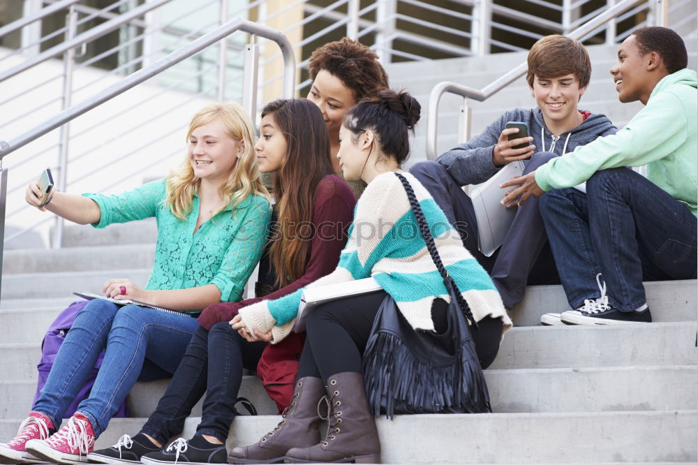 Similar – Multi-ethnic group of young people using smartphone