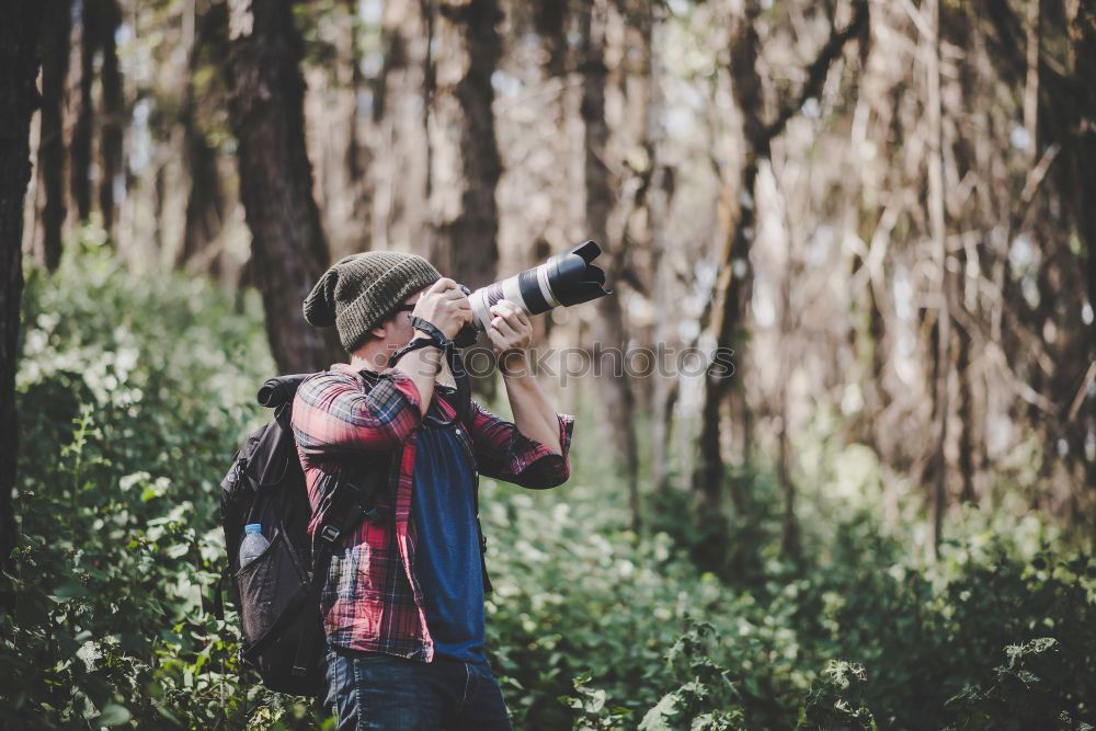 Similar – Hand taking shot of forest