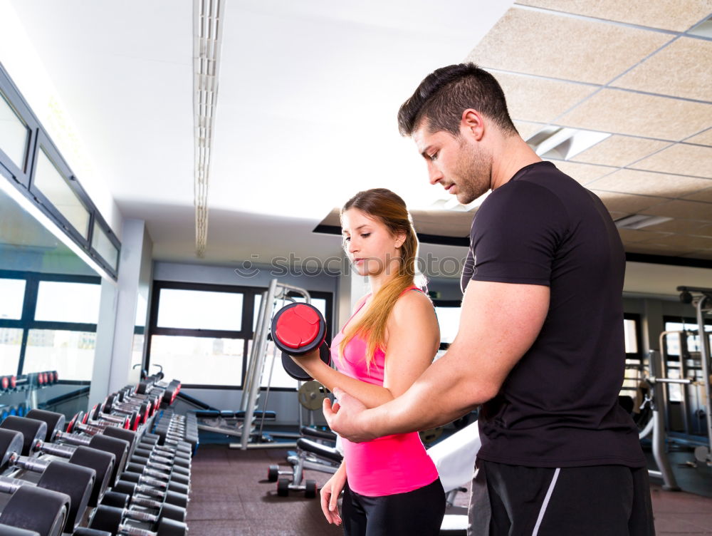 Similar – Female personal trainer helping a young man lift weights