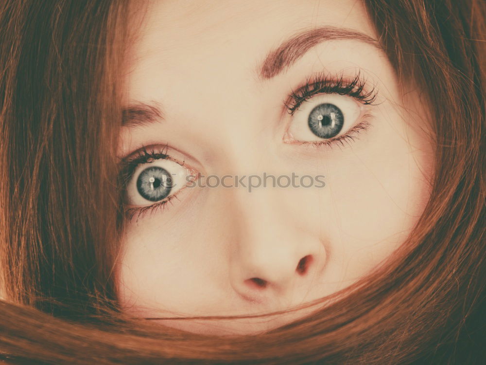 Beautiful, redhead and young woman making a funny face