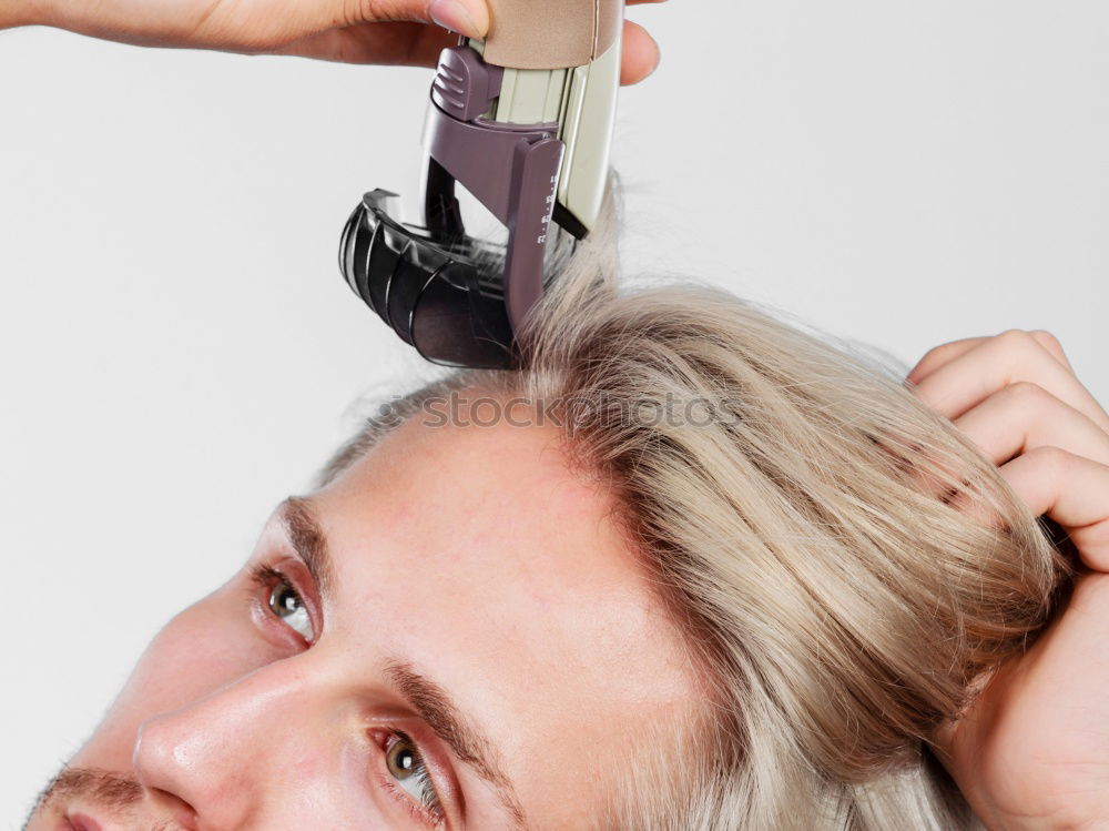 Similar – Barber cutting beard to man in salon