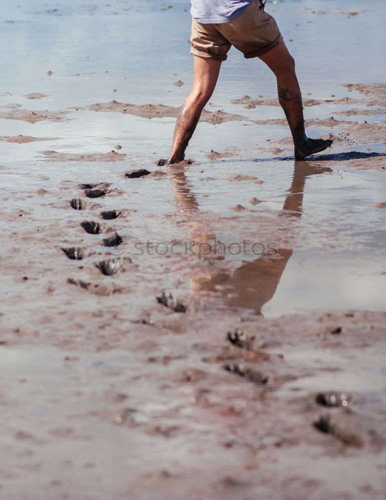 Similar – Men’s legs in water while treading water with jeans rolled up