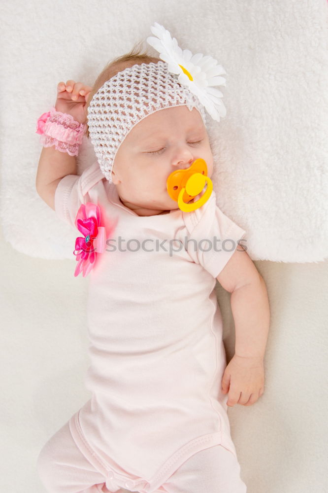 Similar – Baby girl in a bed with toys around.