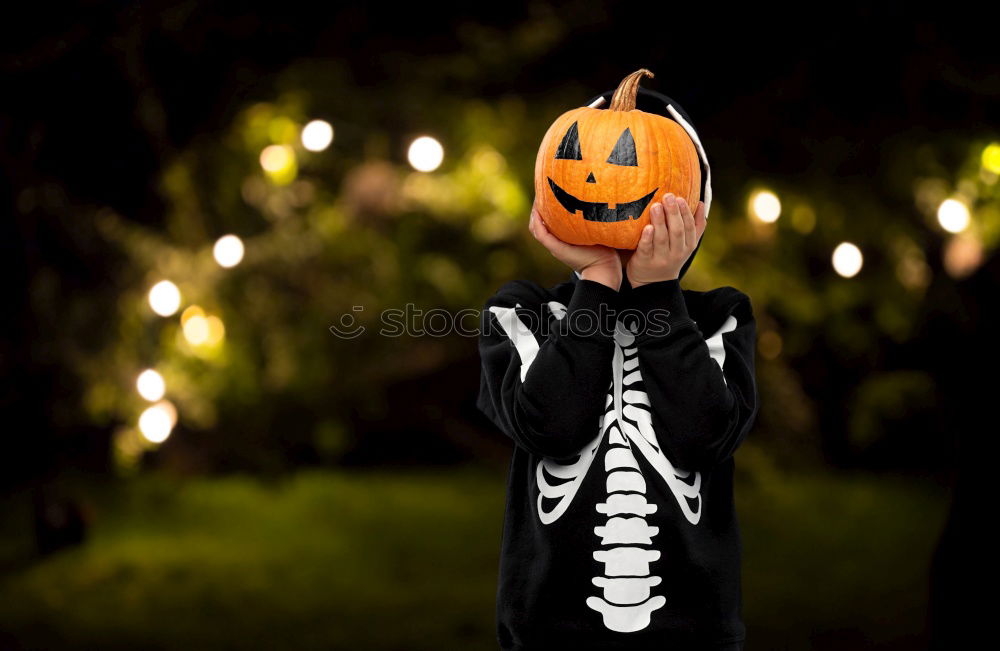 Image, Stock Photo Young boy in the Skeleton costume holding Halloween pumpkin