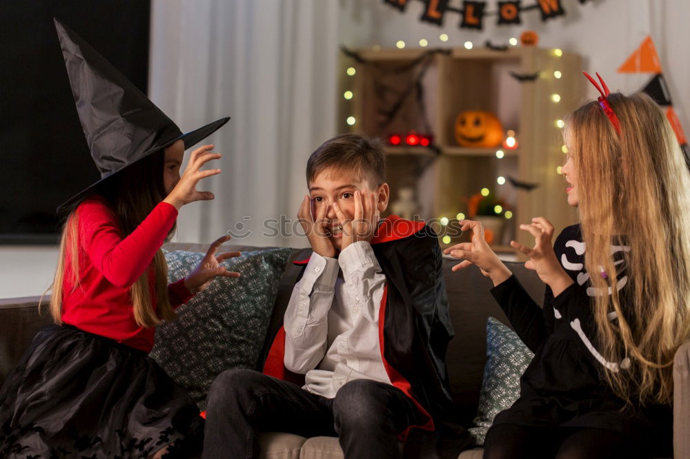 Similar – Image, Stock Photo Happy children disguised decorating a pumpkin at home.