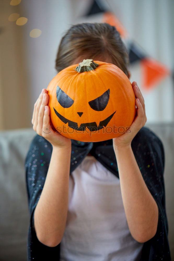 Image, Stock Photo Little girl holding a pumpkin in her hands, on Halloween.