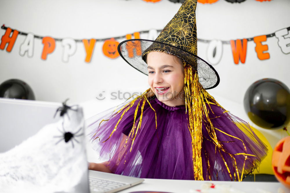 Similar – Beautiful girl disguised of witch decorating a pumpkin at home.